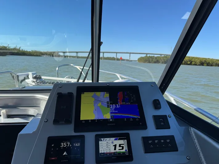 Yacht Photos Pics 2023 Extreme Boats 745 Game King dashboard with navigation screens on a sunny day.