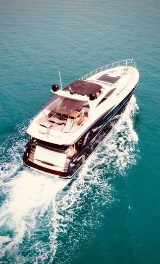  Yacht Photos Pics Luxury 2008 Conam 75 Widebody yacht cruising on turquoise waters.