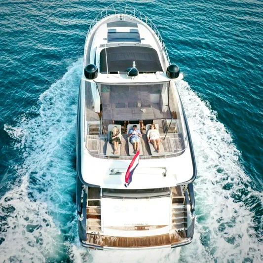  Yacht Photos Pics 2008 Conam 75 Widebody yacht cruising with passengers sunbathing on deck.