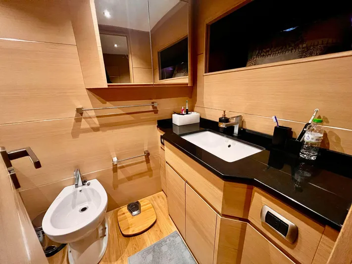  Yacht Photos Pics Luxurious bathroom in 2008 Conam 75 Widebody yacht with modern fixtures and wooden accents.