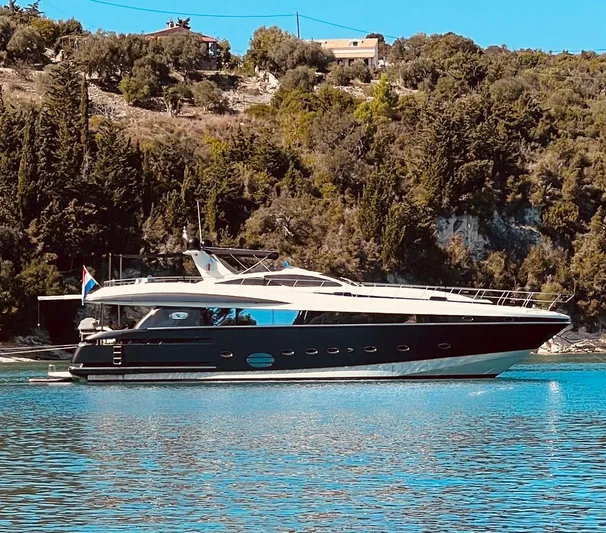  Yacht Photos Pics 2008 Conam 75 Widebody yacht cruising on a serene waterway with lush greenery.