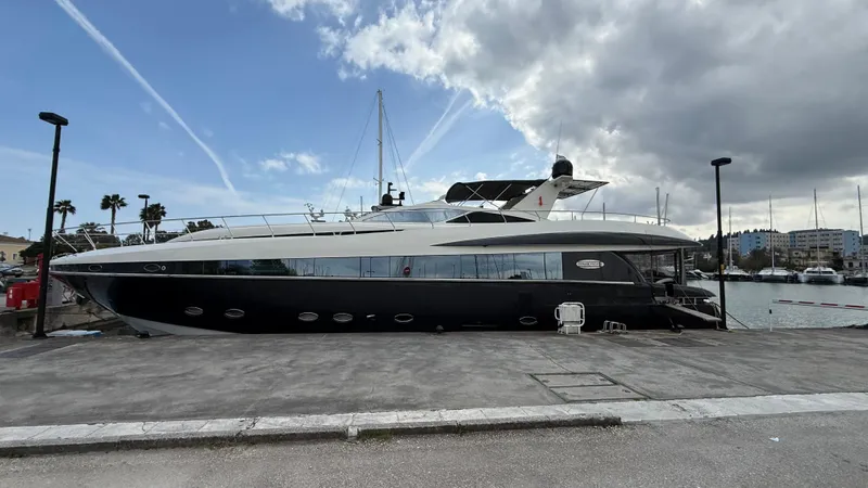  Yacht Photos Pics 2008 Conam 75 Widebody yacht docked at a marina under a partly cloudy sky.