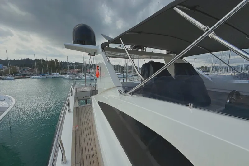  Yacht Photos Pics 2008 Conam 75 Widebody yacht docked in a marina under cloudy skies.