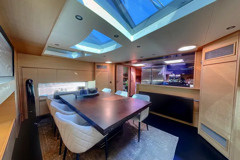  Yacht Photos Pics Luxurious dining area inside a 2008 Conam 75 Widebody yacht with skylights and modern decor.