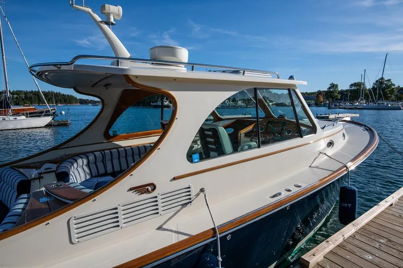 Glory Yacht Photos Pics 2013 Hinckley Talaria 34 yacht docked by the water on a sunny day.