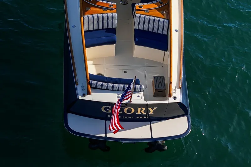 Glory Yacht Photos Pics Aerial view of 2013 Hinckley Talaria 34 boat with striped seating and American flag.