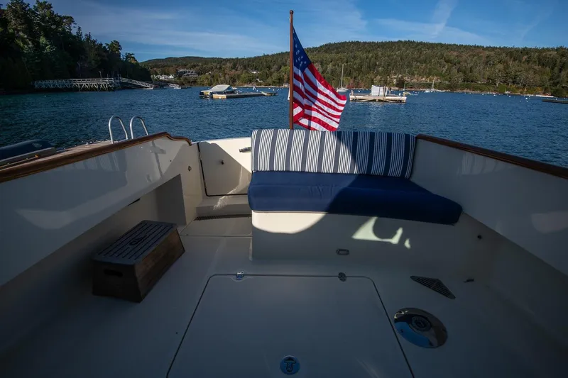 Glory Yacht Photos Pics Hinckley Talaria 34 boat deck with American flag, scenic waterfront view, 2013 model.