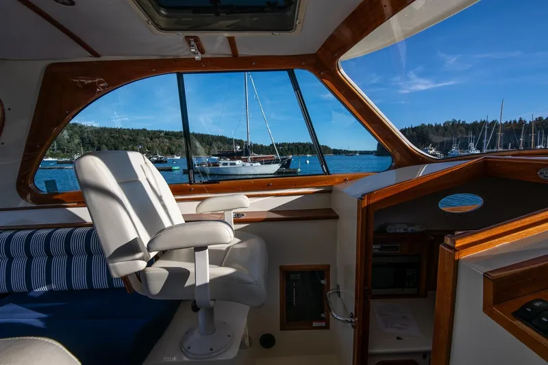 Glory Yacht Photos Pics Interior view of 2013 Hinckley Talaria 34 yacht with scenic harbor backdrop.