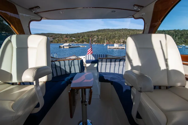 Glory Yacht Photos Pics Interior of 2013 Hinckley Talaria 34 yacht with scenic lake view and comfortable seating.