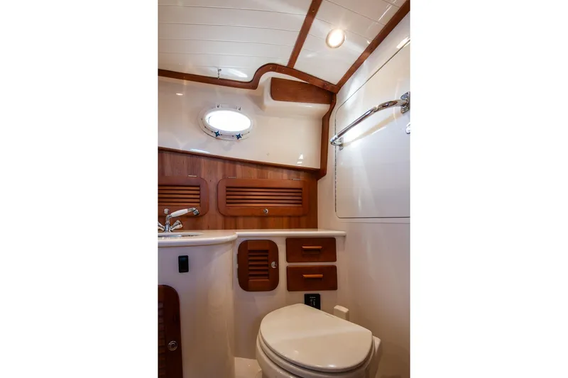 Glory Yacht Photos Pics Luxurious 2013 Hinckley Talaria 34 yacht bathroom with wood accents and modern fixtures.