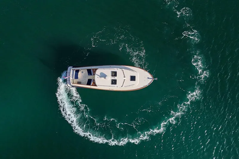 Glory Yacht Photos Pics Aerial view of 2013 Hinckley Talaria 34 yacht cruising in clear waters.