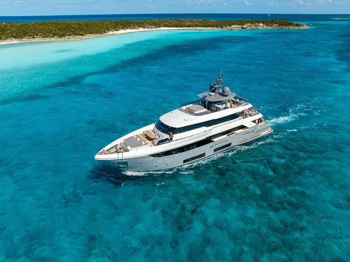 Fifi Yacht Photos Pics Luxurious 2018 Custom Line Navetta 33 yacht cruising in clear turquoise waters.