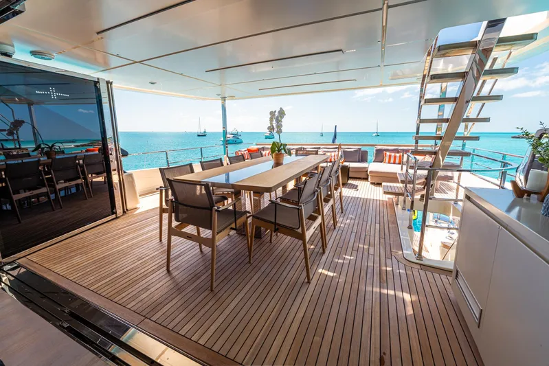 Fifi Yacht Photos Pics Luxurious 2018 Custom Line Navetta 33 yacht deck with dining area and ocean view.