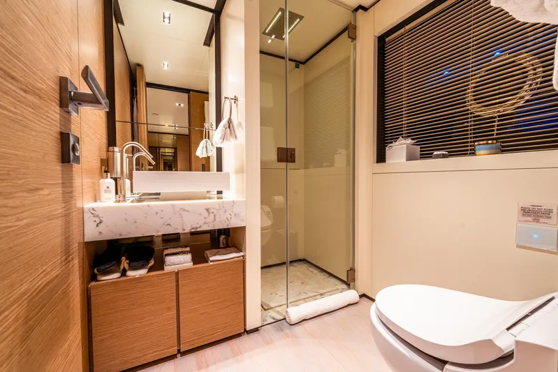 Fifi Yacht Photos Pics Luxurious bathroom in 2018 Custom Line Navetta 33 yacht with modern fixtures and glass shower.