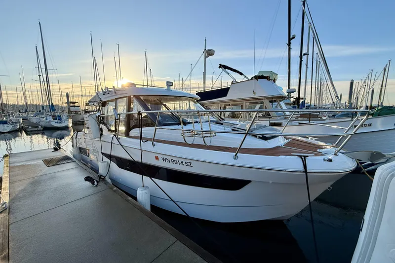  Yacht Photos Pics 2022 Jeanneau NC Weekender 895 docked at marina during sunset.
