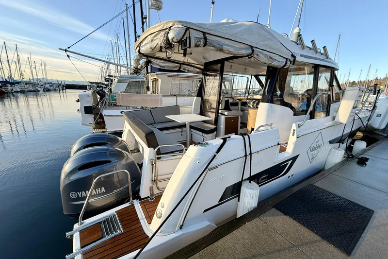 Yacht Photos Pics 2022 Jeanneau NC Weekender 895 docked with twin Yamaha engines.