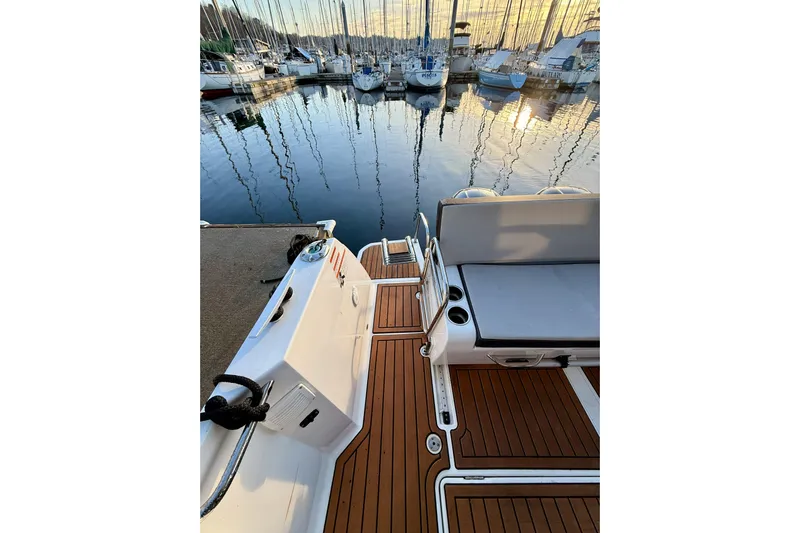  Yacht Photos Pics 2022 Jeanneau NC Weekender 895 docked, showcasing elegant deck and serene marina view.