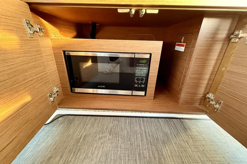  Yacht Photos Pics Microwave in Jeanneau NC Weekender 895 boat's wooden cabinet, 2022 model.