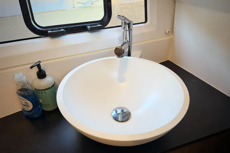  Yacht Photos Pics Modern bathroom sink in 2022 Jeanneau NC Weekender 895 boat, with soap dispensers.