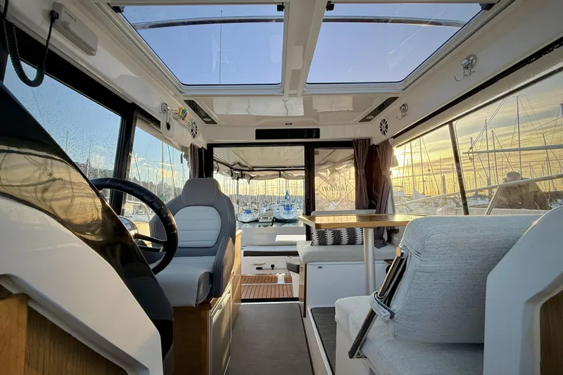  Yacht Photos Pics Interior of 2022 Jeanneau NC Weekender 895 boat with modern seating and panoramic windows.