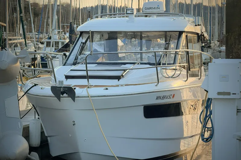  Yacht Photos Pics 2022 Jeanneau NC Weekender 895 docked at marina, front view with anchor and equipment.