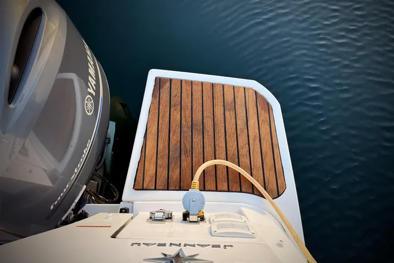  Yacht Photos Pics 2022 Jeanneau NC Weekender 895 with Yamaha engine, wooden deck, and water backdrop.
