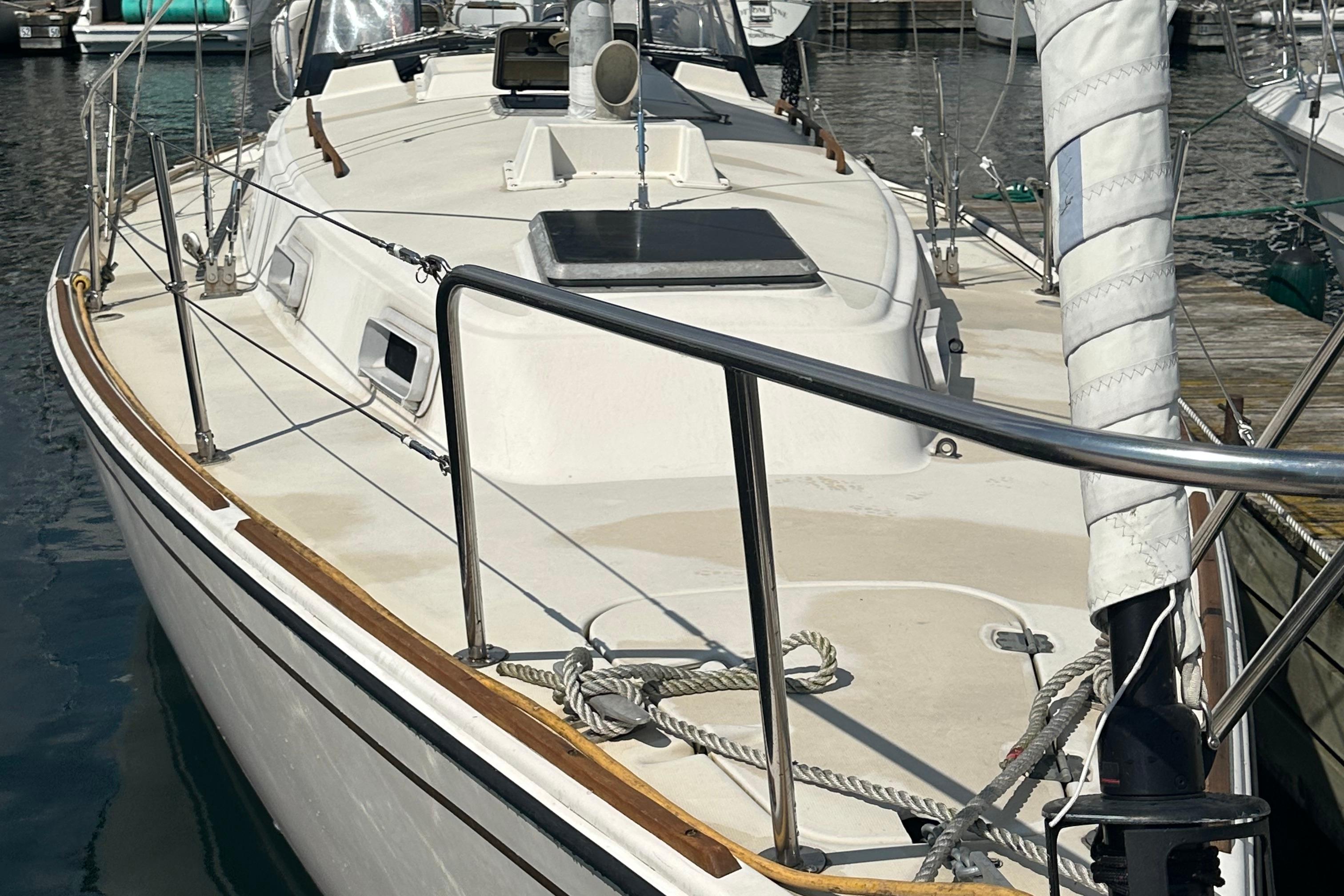 1984 Pearson 34 sailboat docked, showcasing deck and rigging details.