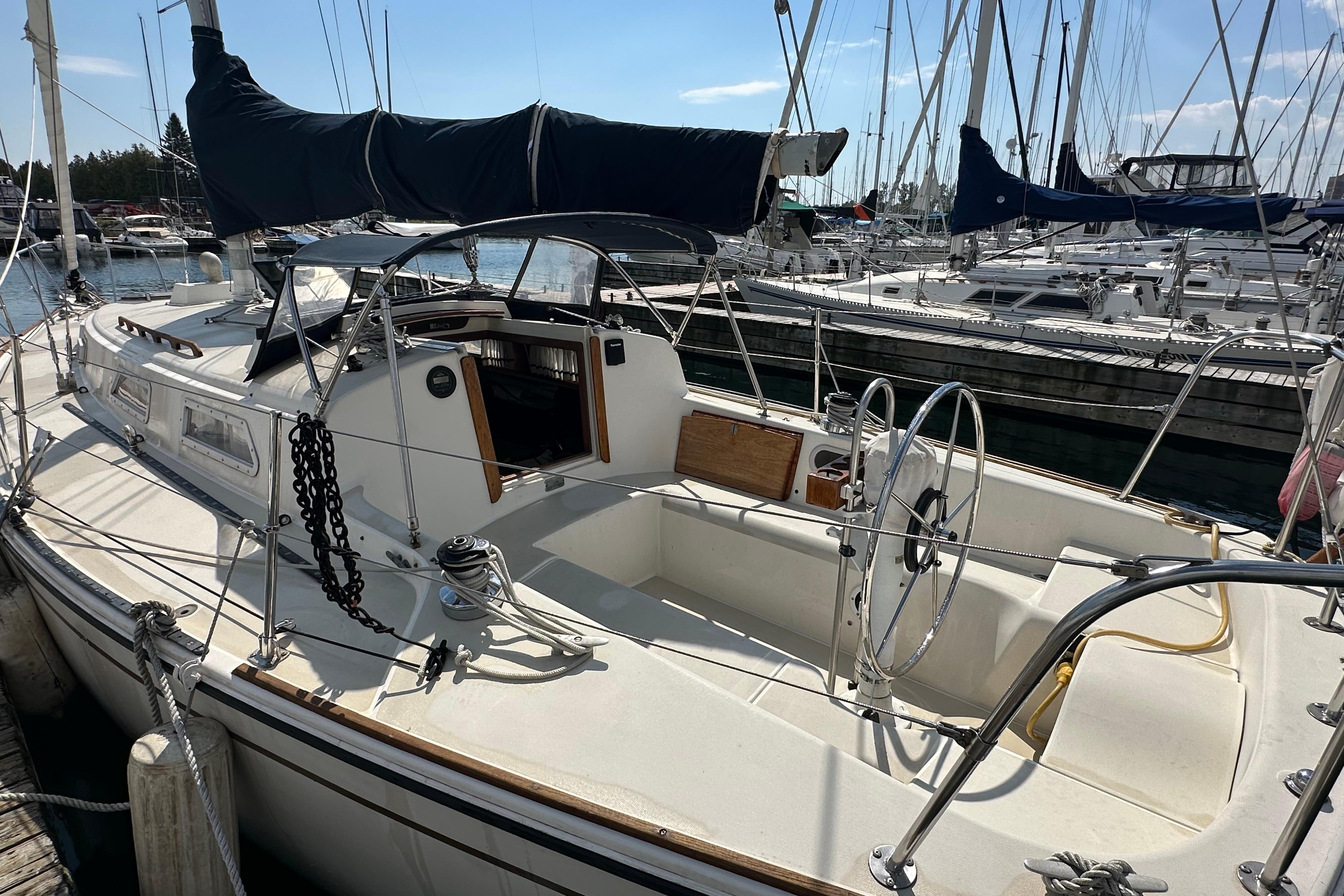 1984 Pearson 34 sailboat docked in marina, featuring spacious cockpit and classic design.