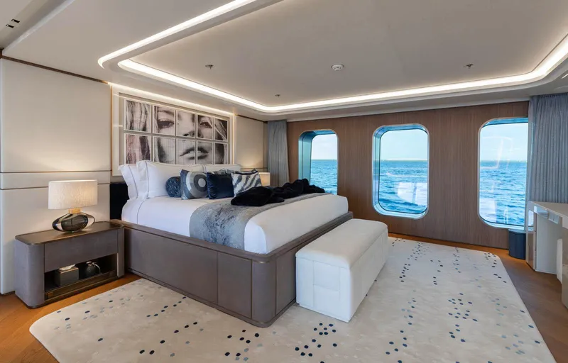 Moonstone Yacht Photos Pics Luxurious bedroom on 2021 Amels 200 yacht with ocean view windows and modern decor.