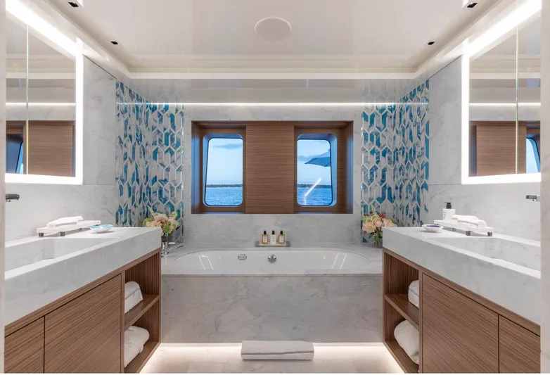 Moonstone Yacht Photos Pics Luxurious bathroom on 2021 Amels 200 yacht with dual sinks and ocean view.