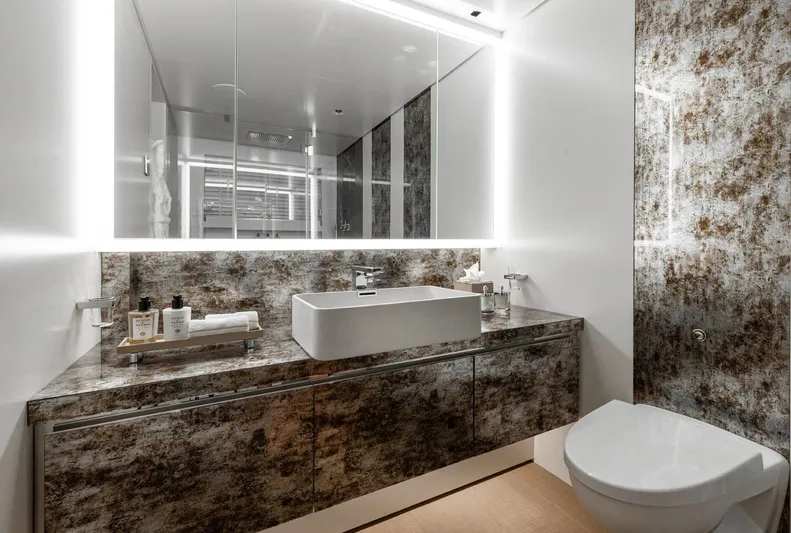 Moonstone Yacht Photos Pics Luxurious bathroom in 2021 Amels 200 yacht with modern sink and illuminated mirror.