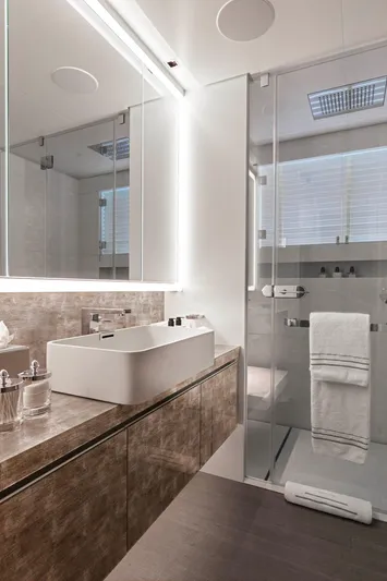 Moonstone Yacht Photos Pics Luxurious bathroom in 2021 Amels 200 yacht with modern fixtures and glass shower.
