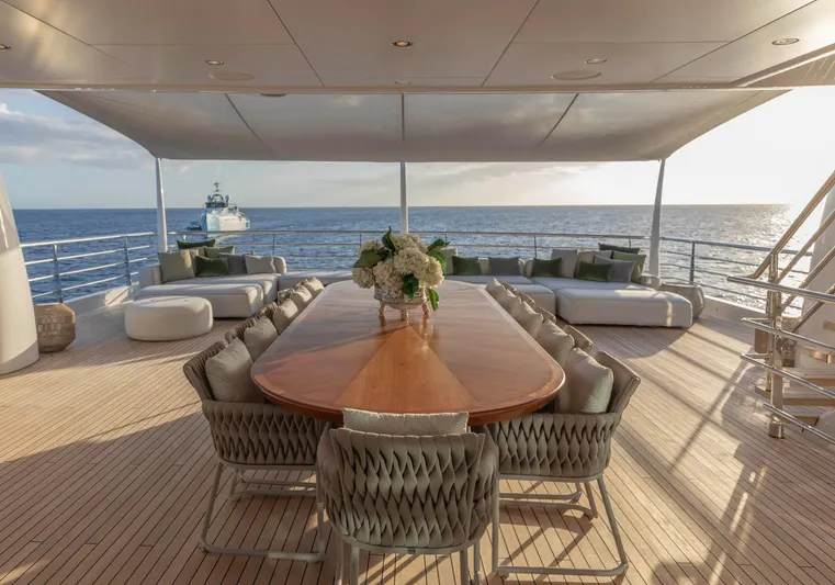 Moonstone Yacht Photos Pics Luxurious Amels 200 yacht deck with elegant dining area, ocean view, and modern seating, 2021 model.