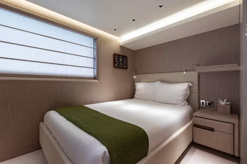 Moonstone Yacht Photos Pics Luxurious bedroom interior on 2021 Amels 200 yacht, featuring modern design and cozy bedding.