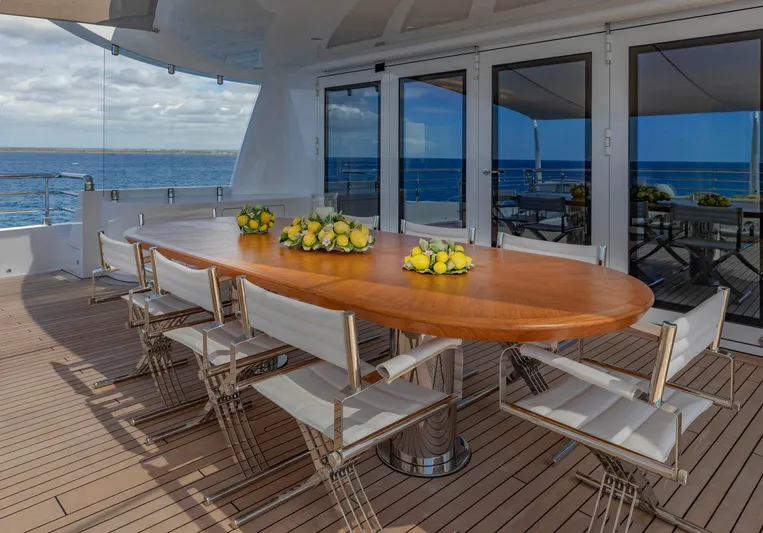 Moonstone Yacht Photos Pics Outdoor dining area on 2021 Amels 200 yacht with ocean view and elegant table setting.
