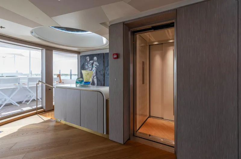 Moonstone Yacht Photos Pics Luxurious interior of 2021 Amels 200 yacht with elevator and modern decor.