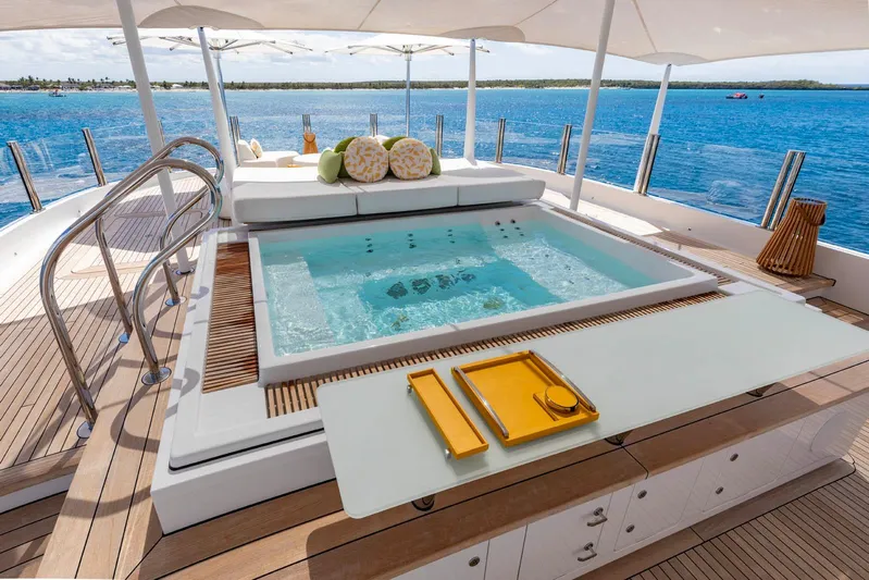 Moonstone Yacht Photos Pics Luxurious Amels 200 yacht deck with jacuzzi, dining area, and ocean view, 2021 model.