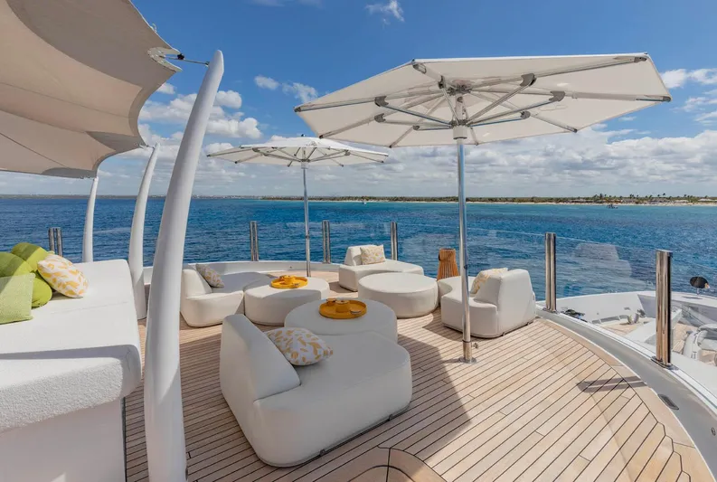 Moonstone Yacht Photos Pics Luxurious deck of 2021 Amels 200 yacht with seating and umbrellas, ocean view.
