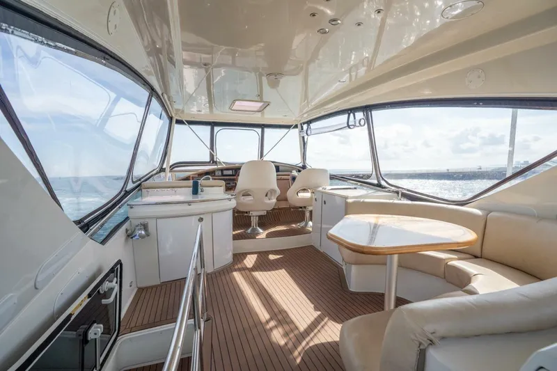 Magic Moments Yacht Photos Pics Luxurious 2006 Marquis 59 yacht interior with elegant seating and panoramic ocean views.