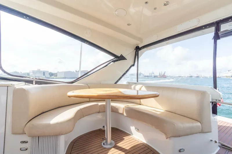 Magic Moments Yacht Photos Pics Luxurious interior of 2006 Marquis 59 yacht with elegant seating and ocean view.