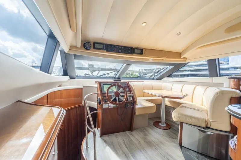 Magic Moments Yacht Photos Pics Luxurious interior of a 2006 Marquis 59 yacht with plush seating and modern helm.