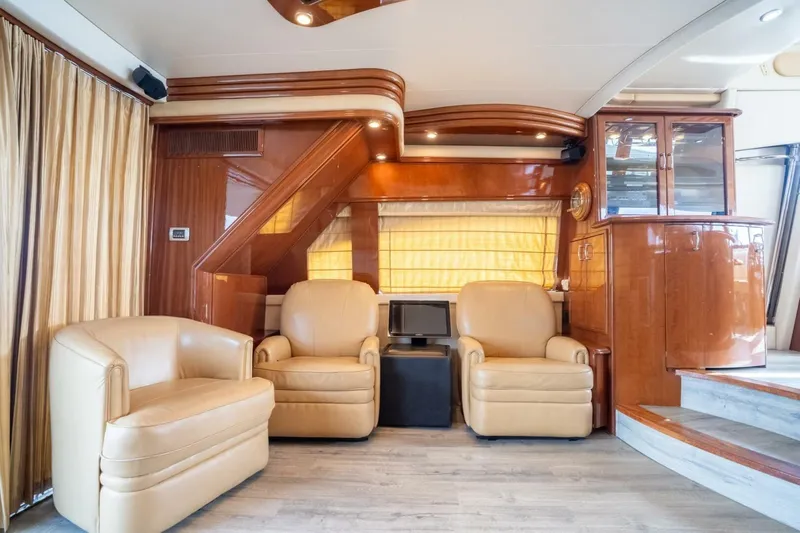 Magic Moments Yacht Photos Pics Luxurious interior of a 2006 Marquis 59 yacht with leather chairs and wooden accents.