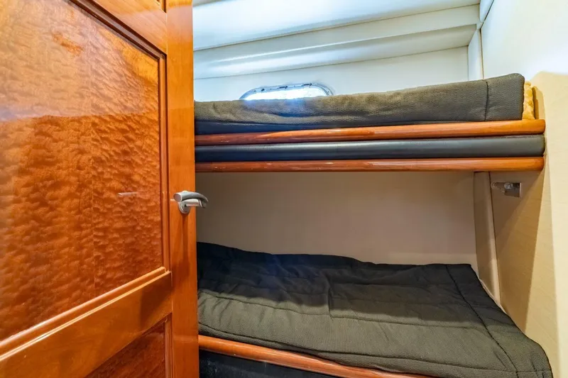 Magic Moments Yacht Photos Pics 2006 Marquis 59 yacht interior with wooden door and cozy bunk beds.