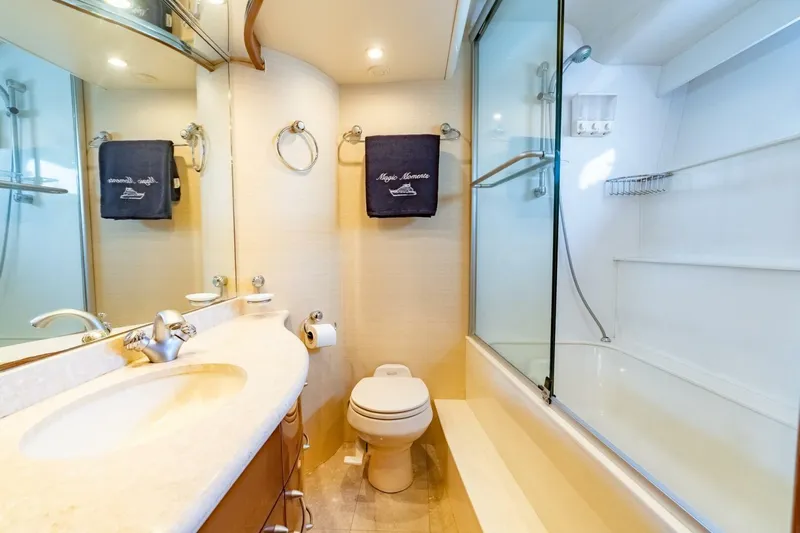 Magic Moments Yacht Photos Pics Luxurious 2006 Marquis 59 yacht bathroom with elegant fixtures and glass-enclosed shower.