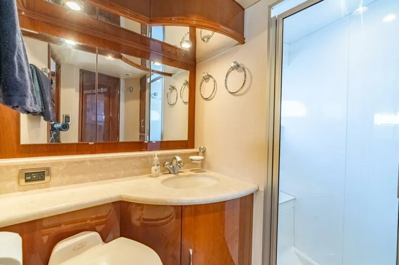 Magic Moments Yacht Photos Pics Luxurious 2006 Marquis 59 yacht bathroom with elegant wood finishes and modern fixtures.