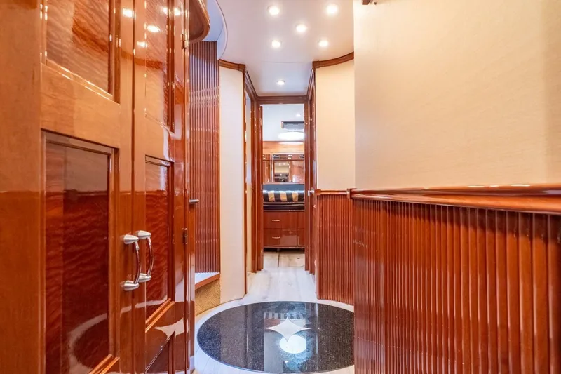 Magic Moments Yacht Photos Pics Luxurious interior hallway of a 2006 Marquis 59 yacht with polished wood finishes.