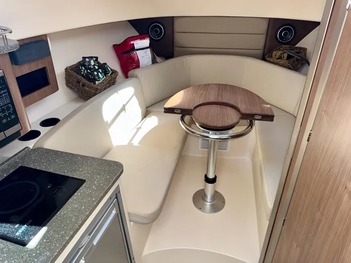  Yacht Photos Pics 2018 Boston Whaler 285 Conquest cabin interior with seating and table.