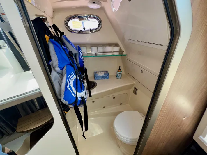  Yacht Photos Pics 2018 Boston Whaler 285 Conquest bathroom with life jackets, toilet, and sink.