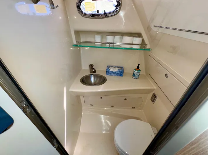  Yacht Photos Pics 2018 Boston Whaler 285 Conquest bathroom with sink, toilet, and storage shelves.