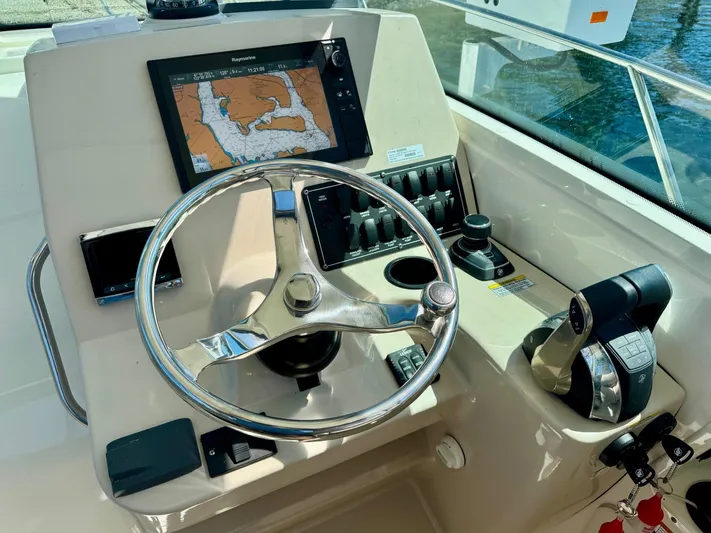  Yacht Photos Pics 2018 Boston Whaler 285 Conquest helm with navigation display and controls.